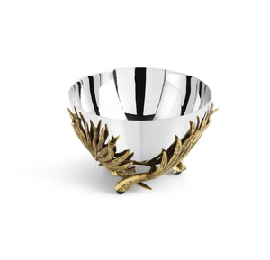 The Michael Aram Palm Nut Dish is a silver metal bowl with sculpted textures and ornate gold-toned branch and leaf designs at the base, shown on a plain white background.