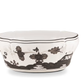 Porcelain bowl from the Ginori 1735 Oriente Italiano Albus Dinnerware Collection, featuring black floral and landscape patterns, a scalloped rim, and decorative detailing.
