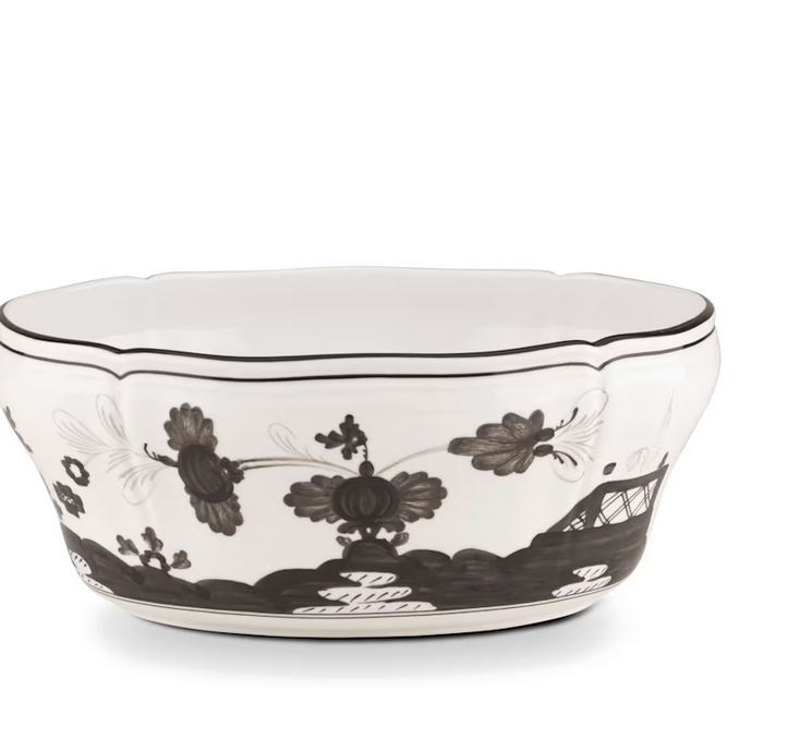 Porcelain bowl from the Ginori 1735 Oriente Italiano Albus Dinnerware Collection, featuring black floral and landscape patterns, a scalloped rim, and decorative detailing.