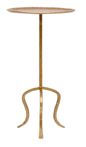 The Fia Table by Made Goods features a tall, round silhouette with an aged brass metal tripod base and thin top, adding modern charm.