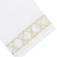 Elevate your home décor with the Haute Home Bamboozle Bath Collection—premium white linen fabric accented by a decorative yellow geometric embroidered trim featuring circles and lines near the edge.