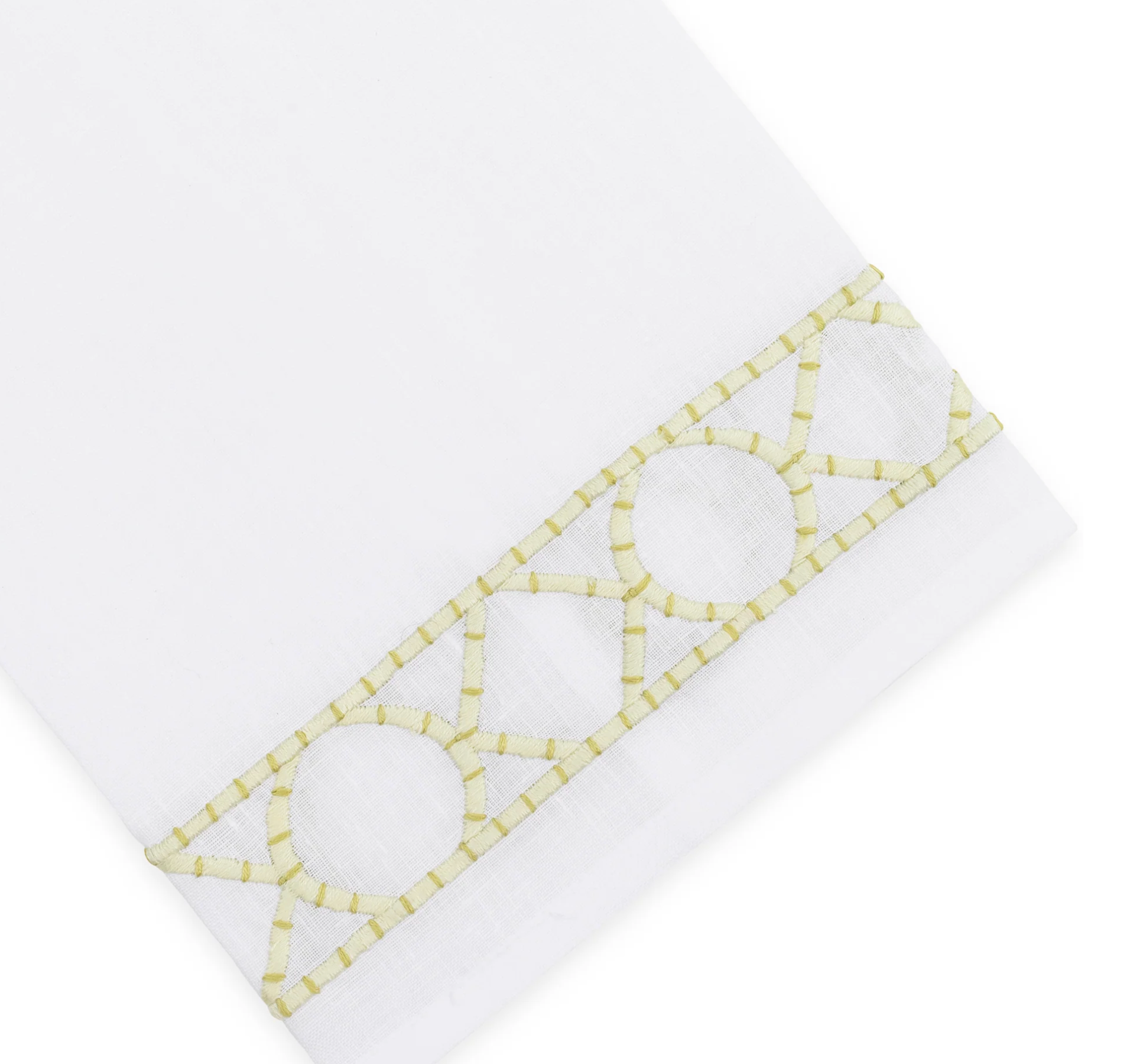 Elevate your home décor with the Haute Home Bamboozle Bath Collection—premium white linen fabric accented by a decorative yellow geometric embroidered trim featuring circles and lines near the edge.