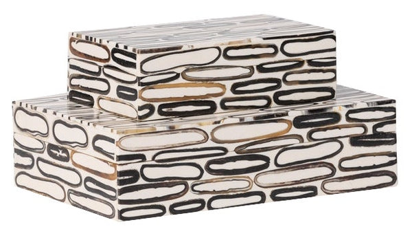 Two rectangular boxes with a modern, abstract pattern of elongated black, white, and brown oval shapes combine burnt horn and white resin details, stacked on top of each other are the Corwin Horn Box, Small by Made Goods.