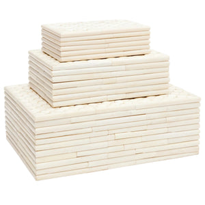 Three stacks of rectangular, light-colored tiles from the Malloy Box Collection by Made Goods are arranged in ascending order on a white background, highlighting their subtle bone pattern.