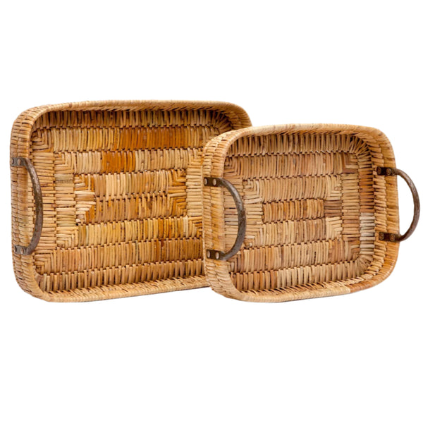 The Made Goods Royston Rectangular Tray Collection features two woven-rattan trays with metal handles, varying in size, arranged side by side.