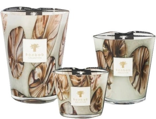 Three Baobab Collection Oceania Anangu candles in hand-blown glass containers of varying sizes.