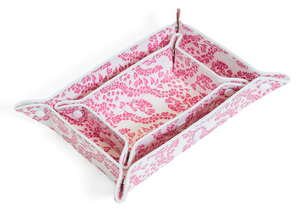 The Luxe Gloss Tray Set Collection by TRVL Design features a rectangular fabric tray with pink and white floral patterns, three compartments for small items, and snap-corner buttons—ideal as a stylish travel organizer.