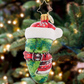 The Christopher Radko Chilly Christmas Pickle Gem Ornament features a festive green pickle with a Santa hat and scarf—perfect for your family’s holiday pickle-hunt tradition.