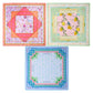 Three colorful scarves from Oh My Mahjong’s Mahjong Mat Collection, each with unique square patterns and borders, are arranged in a triangle on a white background, evoking the lively look of an instructional Mahjong mat.