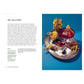 A silver tray with vermouth, green olives, mussels, toothpicks, lemon slice & snail shell—ideal for olive recipes. Recipe from The Little Book of Olives by Abrams shown on the left.