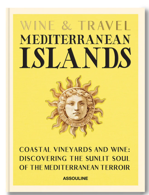 Assouline’s "Wine & Travel Mediterranean Islands" book cover features a sun with a face on a yellow background, with black and gold text highlighting vineyard journeys from Sicilian wines to Greek Assyrtiko discoveries.