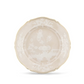 The Oriente Italiano Meringa Dinnerware & Serveware Collection by Ginori 1735 is showcased on a plain white background, featuring ivory porcelain plates adorned with scalloped edges, elegant gold trim, and an intricate white floral and garden motif at the center and along the rim—beautifully exemplifying the timeless artistry of Ginori 1735 porcelain tableware.