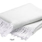 A folded white Pezzo Throw from Matouk, shown with fringe against a plain background. Made from brushed cotton and OEKO-TEX certified, this cozy blanket adds comfort and style to any space.