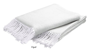 The Matouk Pezzo Throw Collection by Matouk features a soft, folded white cotton blanket with fringed edges. Crafted for cozy comfort, this elegant throw is OEKO-TEX Standard 100 certified for top safety and environmental standards.