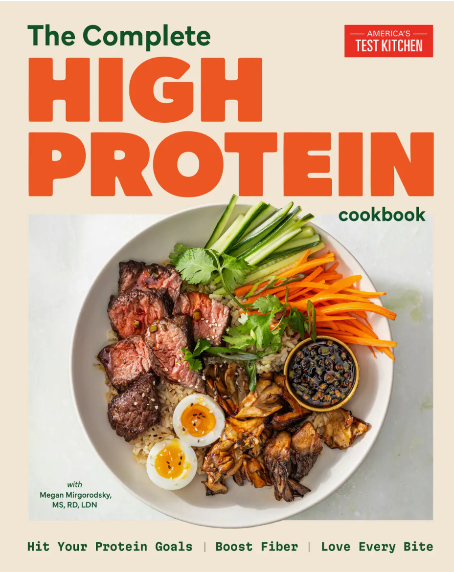 Cover of The Complete High-Protein Cookbook by Penguin Random House, showcasing a bowl filled with beef, eggs, vegetables, and dipping sauce on a light background—your essential resource for high-protein meals and well-balanced meal plans.