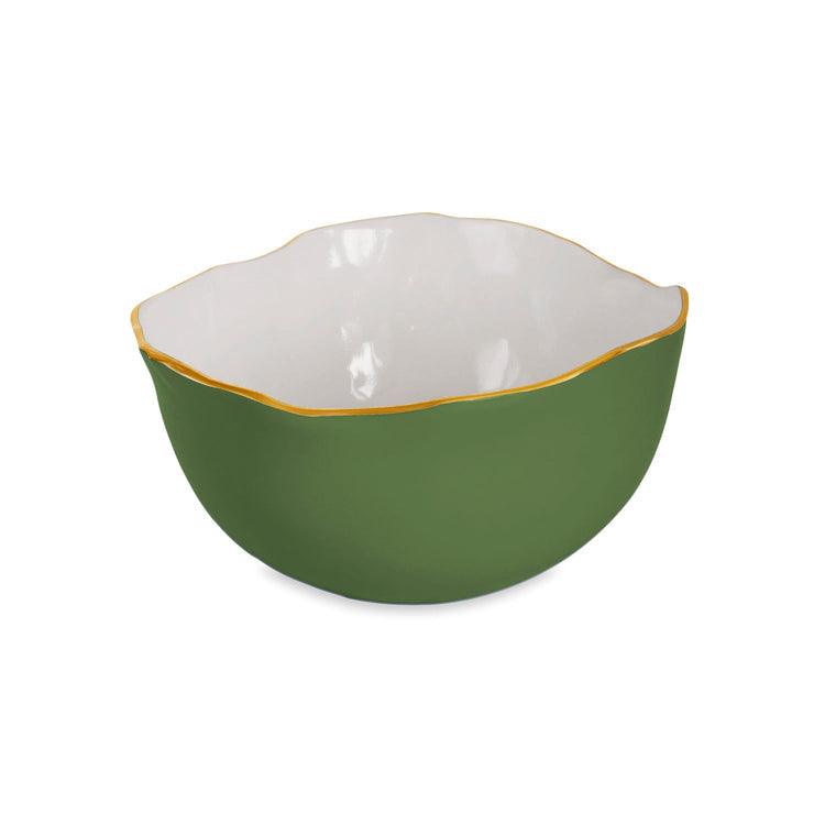 A green and white ceramic bowl from Beatriz Ball’s Encanto Leaf Serveware Collection features a wavy gold rim, artfully photographed on white to highlight its artisanal elegance.