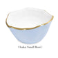 A small, light blue wavy-rim bowl with gold trim made from aluminum alloy—labeled "Osaka Small Bowl"—from Beatriz Ball's Encanto Periwinkle Serveware Collection.