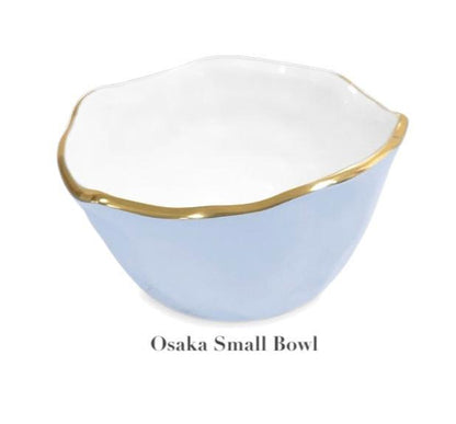A small, light blue wavy-rim bowl with gold trim made from aluminum alloy—labeled "Osaka Small Bowl"—from Beatriz Ball's Encanto Periwinkle Serveware Collection.
