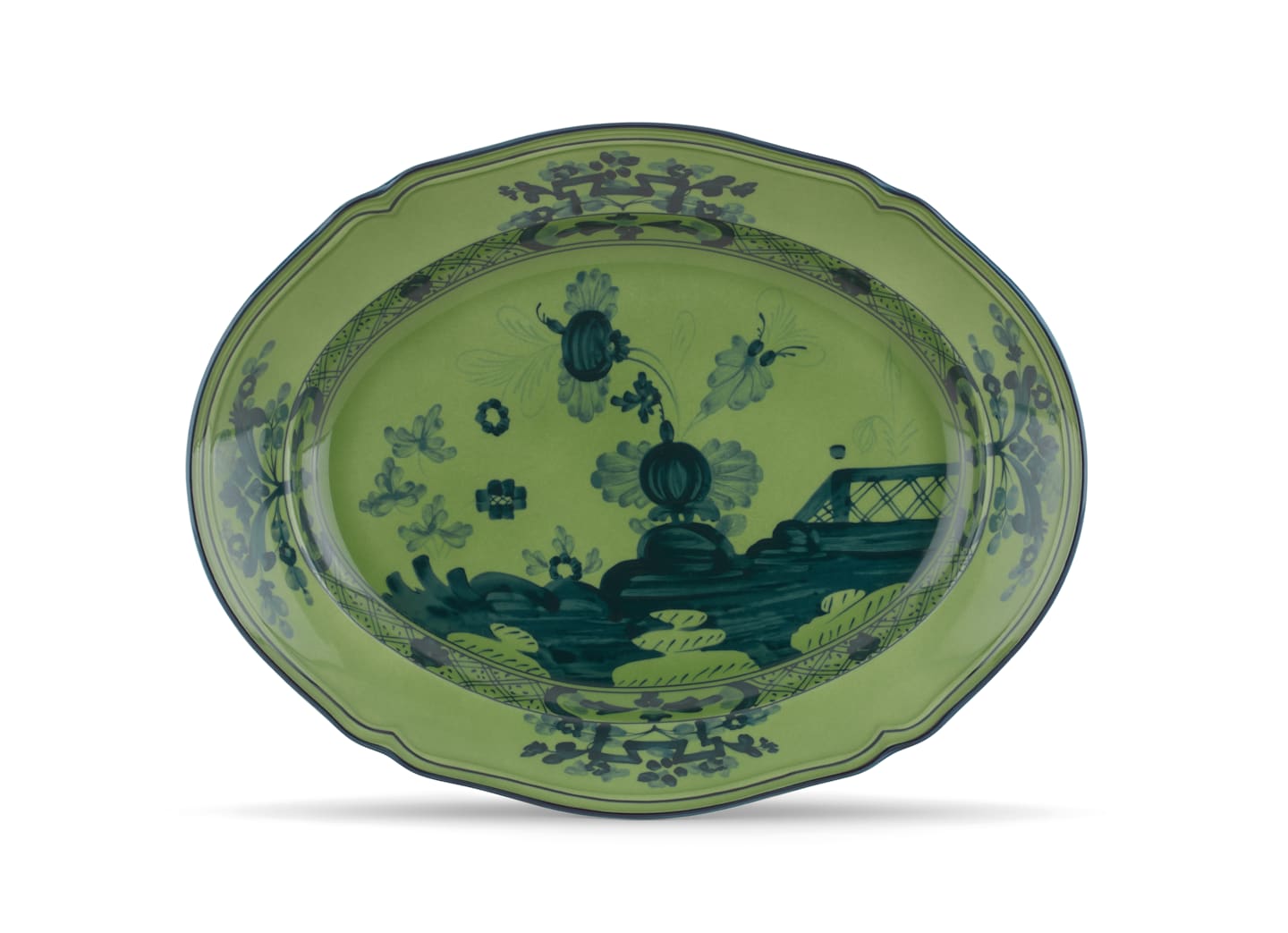 A decorative green ceramic plate from the Ginori 1735 Oriente Italiano Malachite Dinnerware & Decor Collection, featuring dark blue floral and landscape patterns, scalloped edge, and intricate border—ideal for lovers of elegant floral dinnerware.