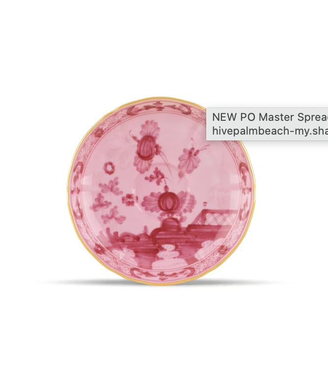 A round porcelain dinner plate from the Ginori 1735 Oriente Italiano Porpora Dinnerware & Decor Collection, featuring a pink floral pattern, a gold rim, and a reflected screen label partially visible on the right side. This exquisite piece embodies the refined elegance characteristic of Oriente Italiano design.