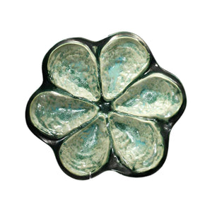 The Mint & Charcoal Serveware Collection by AE Ceramics features a ceramic dish with six petal-shaped sections in a flower-like design, glazed in green and blue—combining style and function for any gathering.
