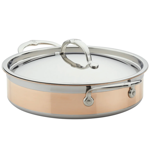 The Hestan CopperBond Copper Induction Sauteuse, 3.5qt, is a stainless steel and copper pan with dual handles and a lid, featuring 5-PLY COPPER INNOVATION. It's induction compatible, ideal for oven-to-table use in any kitchen.