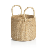 The Zodax Camille Small Round Abaca Basket, crafted from natural fiber and featuring two handles, is shown on a white background.