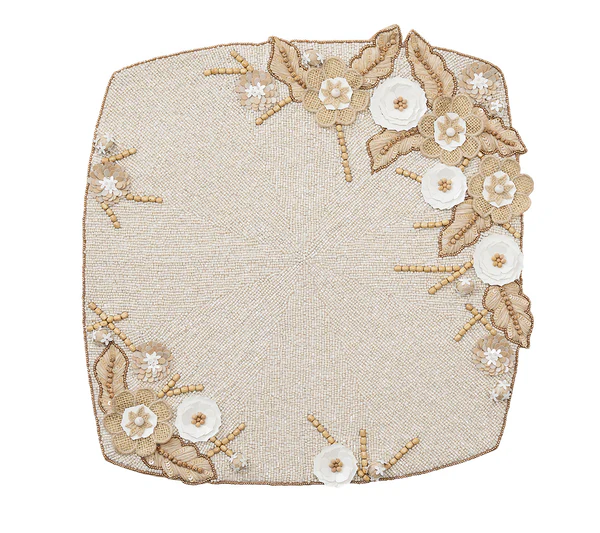 The Kim Seybert Bramble Placemat in Ivory/Natural features hand-embroidered gold and white beaded flowers and leaves on one corner—an elegant touch for your spring table setting.
