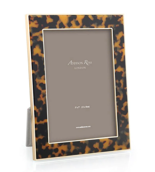 The Addison Ross Tortoiseshell & Gold Photo Frame, sized 5 x 7, elegantly showcases a placeholder card with its faux tortoise shell-patterned design and standing feature. Perfectly polished for sophistication, it comes in a luxury gift box for an ideal presentation.