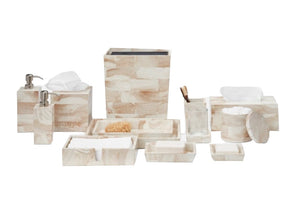 The Pigeon & Poodle PIG Palermo II Collection features a beige and white bath set with faux clamstone accents—tissue box, soap dispenser, trays, jars, and holders—artfully displayed on a white background.