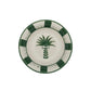 From the Casa Dark Jungle Dinnerware Collection by Johanna Ortiz: a round ceramic plate with a hand-painted green palm tree at the center and a green and white checkered border, celebrating artisanal heritage.