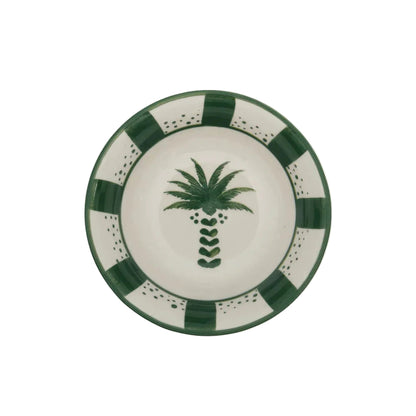 From the Casa Dark Jungle Dinnerware Collection by Johanna Ortiz: a round ceramic plate with a hand-painted green palm tree at the center and a green and white checkered border, celebrating artisanal heritage.