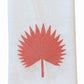 Introducing the Haute Home Palm Leaf Bath Collection: a white Italian linen cloth napkin adorned with a coral pink embroidered palm leaf motif at its center.