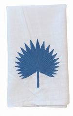 Introducing the Palm Leaf Bath Collection by Haute Home: a white cloth napkin elegantly crafted from fine Italian linen, featuring a blue palm leaf embroidered at its center. Elevate your table setting by pairing it with matching tip towels or a coordinated tissue box cover for a refined, cohesive look.