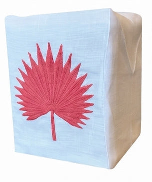 The Palm Leaf Bath Collection tissue box cover by Haute Home is crafted from fine Italian linen and features a red embroidered palm leaf design on the front.