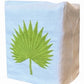 Elevate your space with the Haute Home Palm Leaf Bath Collection: a white Italian linen tissue box cover featuring an embroidered green palm leaf design on the front, echoing the refined look of an elegant tip towel.