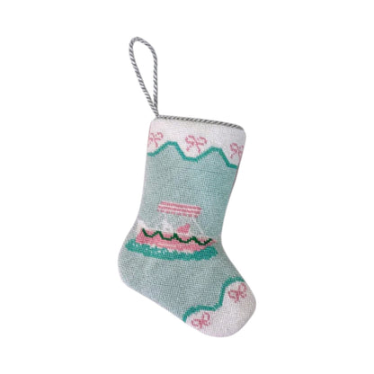 The Palm Yacht Needle Point Stocking by Bauble Stockings is a light blue and white nautical ornament, accented with pink and green patterns, a hanging loop, and detailed hand-stitched needlepoint craftsmanship.