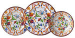 Three plates from the Mario Luca Giusti Pancale White Melamine Dinnerware Collection feature vibrant blue, orange, green, and red floral and butterfly motifs, artfully overlapping each other.