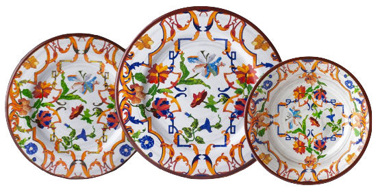 Three plates from the Mario Luca Giusti Pancale White Melamine Dinnerware Collection feature vibrant blue, orange, green, and red floral and butterfly motifs, artfully overlapping each other.