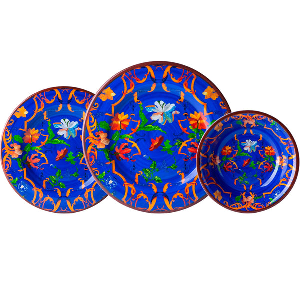 Three vibrant blue plates with orange floral patterns and red rims from the Mario Luca Giusti Pancale Blue Collection are arranged in a row, ideal for outdoor entertaining with their durable melamine construction.