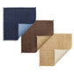 Three square fabric swatches in navy, brown, and beige with a classic basketweave pattern inspire the versatile Kim Seybert Vista Reversible Placemat—ideal for any reversible placemat design.