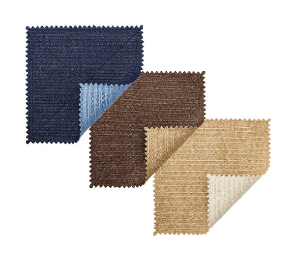 Three square fabric swatches in navy, brown, and beige with a classic basketweave pattern inspire the versatile Kim Seybert Vista Reversible Placemat—ideal for any reversible placemat design.