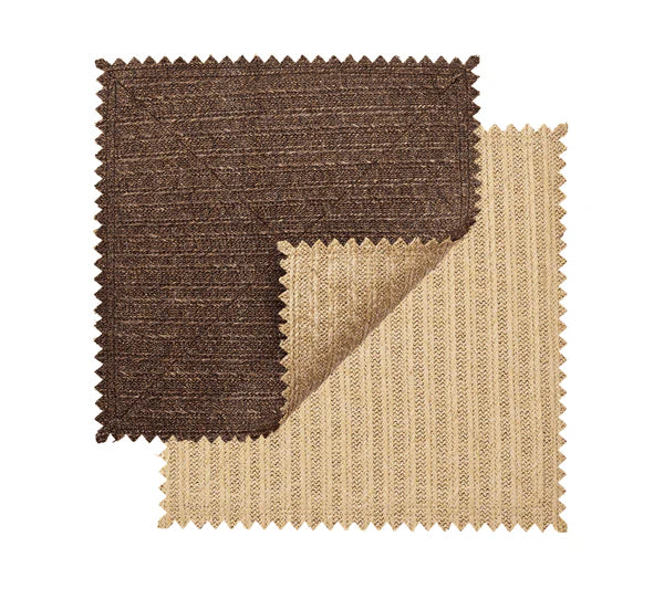 Two rectangular fabric swatches with zigzag edges, one brown and one beige, overlap on a white background, highlighting the subtle basketweave pattern of the Kim Seybert Vista Reversible Placemat.