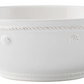 A white ceramic bowl from Juliska's Berry & Thread Classic Whitewash Dinnerware Collection features a subtle textured rim with small dot patterns—ideal as a pasta bowl or to pair with your favorite plates.