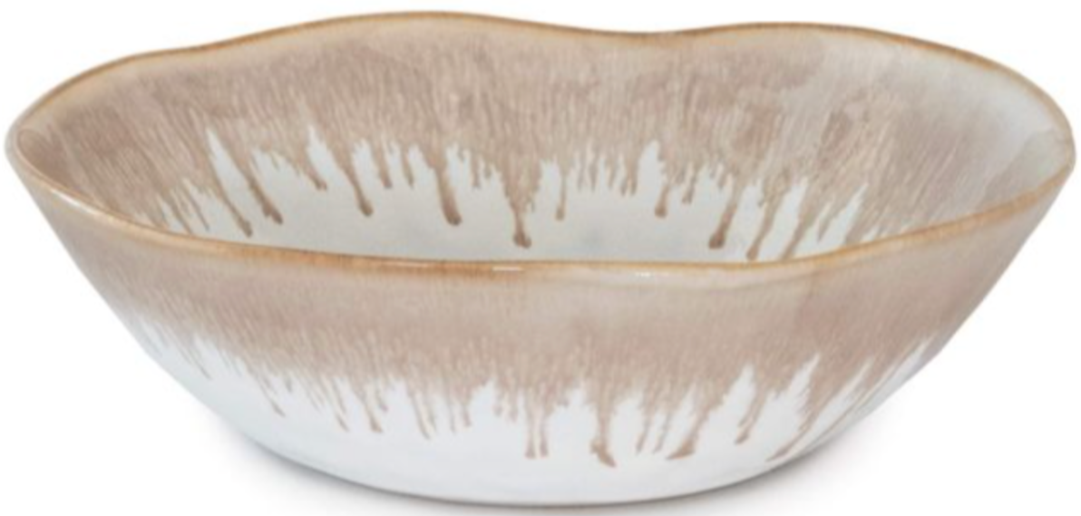 The Burlington Bluff Dinnerware Collection by Simon Pearce features a shallow ceramic cereal bowl with a wavy rim and a beige and white Bluff glaze, inspired by classic pinch-pot designs.
