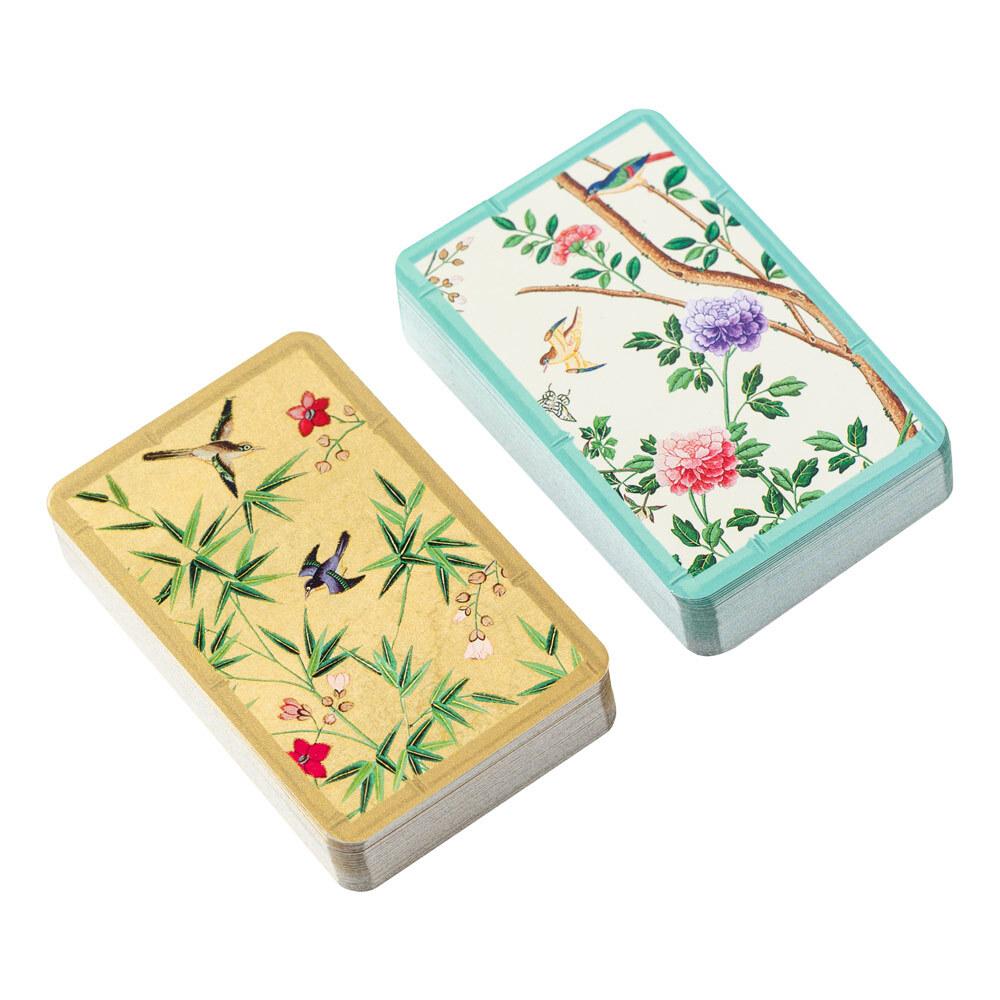 The Caspari Chinese Wallpaper Bridge Collection includes two rectangular card decks with decorative covers of birds, flowers, and bamboo—ideal for your next social card game.