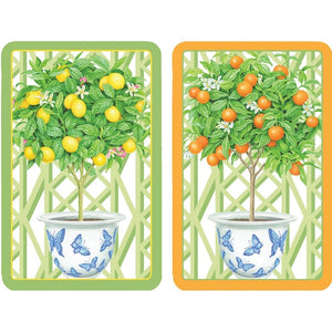Two citrus topiaries—one with yellow lemons, one with orange fruits—stand in butterfly-adorned pots. This Caspari Citrus Topiaries Bridge Collection evokes the charm of a friendly group card game.