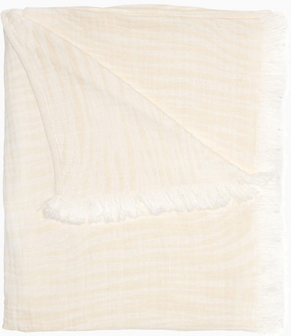 The Daasu Throw Collection by John Robshaw features a cream-colored, stonewashed cotton throw with subtle stripes and fringed edges, displayed against a white background.