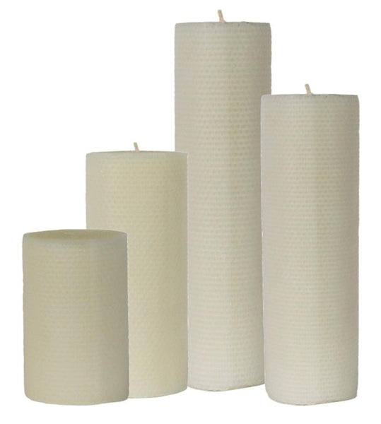 The Perin-Mowen Connoisseur Pillar Candle Collection by Perin Mowen features four pure beeswax pillar candles in a row, each elegantly designed with a subtle honeycomb texture.