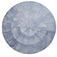The Kim Seybert Capiz Placemat features concentric circles and radial lines, dividing the surface into sections and creating a striking table backdrop.